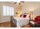 Guest bedroom with wrought iron bed frame, comfortable seating, and hardwood floors at 2554 E Honeysuckle Pl, Chandler, AZ 85286