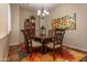 Formal dining room with hardwood floors, chandelier, and seating for six at 2554 E Honeysuckle Pl, Chandler, AZ 85286