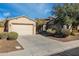 Single-story home with a two-car garage and well-manicured landscaping at 2554 E Honeysuckle Pl, Chandler, AZ 85286