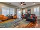 Spacious living room with hardwood floors, comfortable seating, and large windows at 2554 E Honeysuckle Pl, Chandler, AZ 85286