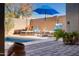 Relaxing pool area with lounge chairs, umbrella, and brick patio at 2554 E Honeysuckle Pl, Chandler, AZ 85286