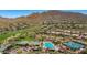 Aerial view of the community showcasing lush landscaping, pool, and mountain views at 41716 N Laurel Valley Way, Anthem, AZ 85086