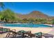 Scenic pool area with lounge chairs and mountain views at 41716 N Laurel Valley Way, Anthem, AZ 85086