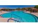 Outdoor swimming pool with lap lanes, lounge chairs, and shade canopies in the background at 41716 N Laurel Valley Way, Anthem, AZ 85086