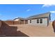 Spacious dirt backyard with block wall and grey house exterior at 7637 W Minton St, Laveen, AZ 85339
