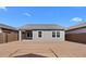 View of home's exterior and backyard with block wall at 7637 W Minton St, Laveen, AZ 85339