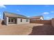 Large dirt backyard with covered patio and view of the house at 7637 W Minton St, Laveen, AZ 85339