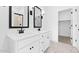 Bright bathroom with double sink vanity and black framed mirrors at 7637 W Minton St, Laveen, AZ 85339