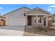 Charming single-Gathering home with a two-car garage, a covered porch, and desert landscaping at 7637 W Minton St, Laveen, AZ 85339