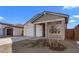 Single-Gathering home with a two-car garage, a covered porch, and newly planted tree in the front yard at 7637 W Minton St, Laveen, AZ 85339