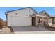 Single-Gathering home with a two-car garage, a covered porch, and desert landscaping on a sunny day at 7637 W Minton St, Laveen, AZ 85339