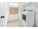 Clean laundry room with washer, dryer, and overhead shelving at 7637 W Minton St, Laveen, AZ 85339