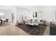 Bright living room showcasing a neutral color palette, contemporary furniture, and stylish geometric area rug at 7637 W Minton St, Laveen, AZ 85339