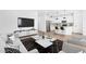 A modern living room showcasing the kitchen, with a kitchen island, counter seating, and stainless appliances at 7637 W Minton St, Laveen, AZ 85339