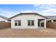 View of the home's backyard featuring a clean, white exterior and block wall at 7641 W Minton St, Laveen, AZ 85339