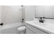 Modern bathroom featuring a white vanity, sink, and a tub with white tile surround at 7641 W Minton St, Laveen, AZ 85339