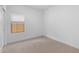 Neutral bedroom featuring carpet floors, a window with blinds, and a closet at 7641 W Minton St, Laveen, AZ 85339