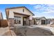 New construction home featuring a gravel yard and a wide driveway leading to a two car garage and stone pillar accents at 7641 W Minton St, Laveen, AZ 85339