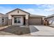 Charming single-story home featuring a low maintenance yard and a two car garage, with stone pillar accents at 7641 W Minton St, Laveen, AZ 85339