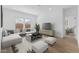 Bright living room with a comfortable sectional sofa, modern furnishings, and wood-look flooring at 7641 W Minton St, Laveen, AZ 85339