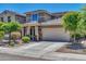 Two-story house with beige exterior, landscaped yard, and two-car garage at 8953 W Townley Ave, Peoria, AZ 85345