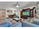 Living room with gray sectional sofa and large TV at 8953 W Townley Ave, Peoria, AZ 85345