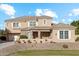 Two story house with beige exterior, stone accents, and landscaping at 950 E Desert Inn Dr, Chandler, AZ 85249