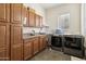 Laundry room with washer, dryer, and extensive cabinetry at 950 E Desert Inn Dr, Chandler, AZ 85249