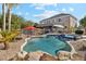 Inviting kidney shaped pool with surrounding rocks at 950 E Desert Inn Dr, Chandler, AZ 85249