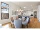 Bright dining area features a glass table, upholstered chairs, and open access to the kitchen with bar seating at 11885 N Sunset Vista Dr, Fountain Hills, AZ 85268