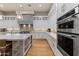 Modern kitchen features stainless steel appliances, white cabinets, a center island, and hardwood flooring at 11885 N Sunset Vista Dr, Fountain Hills, AZ 85268