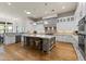 Spacious kitchen with white cabinets, stainless appliances, a large island, and hardwood flooring at 11885 N Sunset Vista Dr, Fountain Hills, AZ 85268
