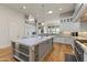 Kitchen showcasing a central island, white cabinets, stainless steel appliances, and wood floors at 11885 N Sunset Vista Dr, Fountain Hills, AZ 85268