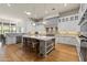 Well-lit kitchen with a large island, white cabinetry, stainless steel appliances, and hardwood floors at 11885 N Sunset Vista Dr, Fountain Hills, AZ 85268