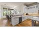 Bright kitchen featuring a breakfast bar, white cabinets, stainless steel appliances, and hardwood floors at 11885 N Sunset Vista Dr, Fountain Hills, AZ 85268