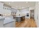 Spacious kitchen with white cabinetry, marble countertops, mosaic backsplash, and a central island with seating at 11885 N Sunset Vista Dr, Fountain Hills, AZ 85268