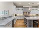 Bright kitchen featuring white cabinetry, marble countertops, stainless steel appliances, and wood flooring at 11885 N Sunset Vista Dr, Fountain Hills, AZ 85268