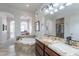 Elegant bathroom with soaking tub, double vanity, and separate shower at 1351 E Artemis Trl, Queen Creek, AZ 85140