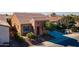 Home's exterior features a brick facade, blue shutters, and a front patio at 1351 E Artemis Trl, Queen Creek, AZ 85140
