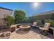 Landscaped backyard with fire pit and seating at 1351 E Artemis Trl, Queen Creek, AZ 85140