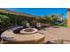 Curved fire pit in a brick patio area at 1351 E Artemis Trl, Queen Creek, AZ 85140