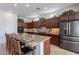 Kitchen island with granite countertop and seating area at 1351 E Artemis Trl, Queen Creek, AZ 85140
