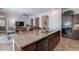 Island kitchen with granite countertops and dark wood cabinets at 1351 E Artemis Trl, Queen Creek, AZ 85140