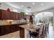 Spacious kitchen with granite countertops and dark wood cabinets at 1351 E Artemis Trl, Queen Creek, AZ 85140