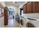 Bright laundry room with washer, dryer, and ample cabinetry at 1351 E Artemis Trl, Queen Creek, AZ 85140