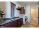 Laundry room features dark wood cabinets and a granite countertop at 1351 E Artemis Trl, Queen Creek, AZ 85140