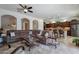 Spacious living room with large sectional sofa and tile floors at 1351 E Artemis Trl, Queen Creek, AZ 85140