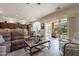 Open living area featuring a sectional sofa and access to backyard at 1351 E Artemis Trl, Queen Creek, AZ 85140