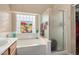 Bathroom with shower, bathtub, and a stained glass window at 1435 E Debbie Dr, San Tan Valley, AZ 85140