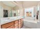 Double sink bathroom with a soaking tub and walk-in shower at 1435 E Debbie Dr, San Tan Valley, AZ 85140